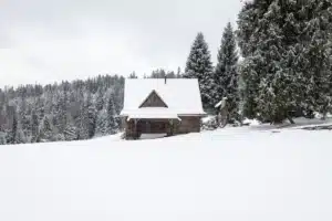 Paysage enneigé hivernal doux et réconfortant avec lumière chaleureuse au loin