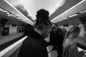 Personne portant un casque ANC dans un train, ajustant les écouteurs pendant un trajet