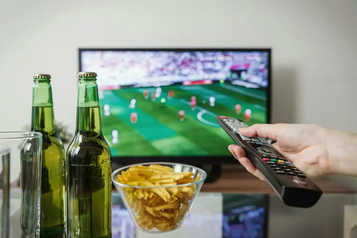 Personne regardant une tablette pour du streaming près d'une fenêtre en journée